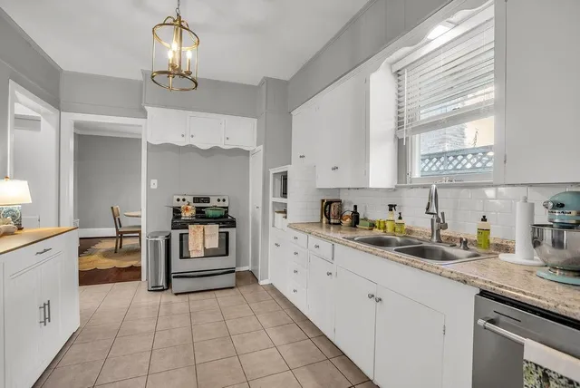a kitchen with cabinets and window
