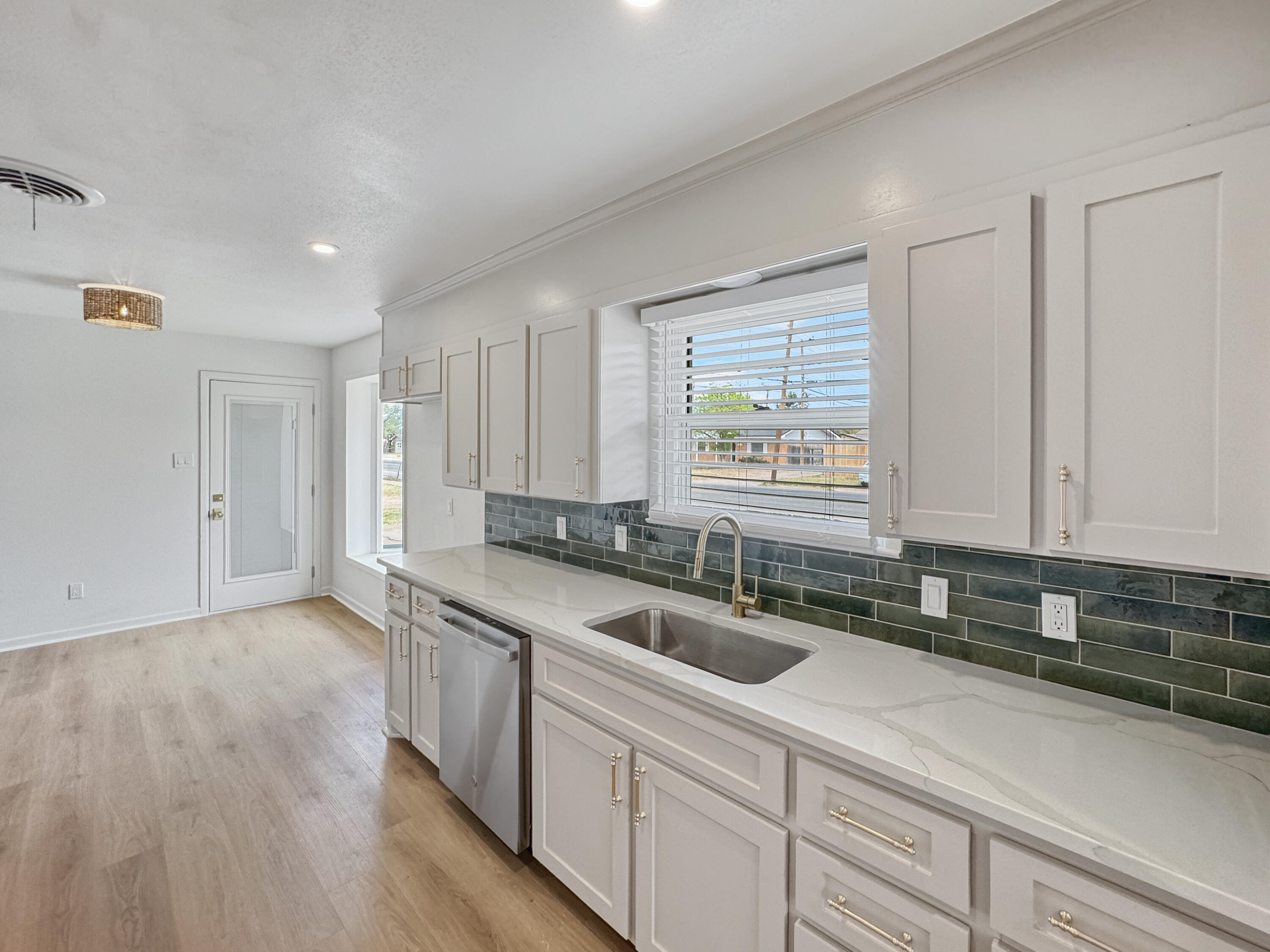 5502 8th Street Lubbock, TX 79416 - Photo 13 of 41 a kitchen with a sink cabinets and window