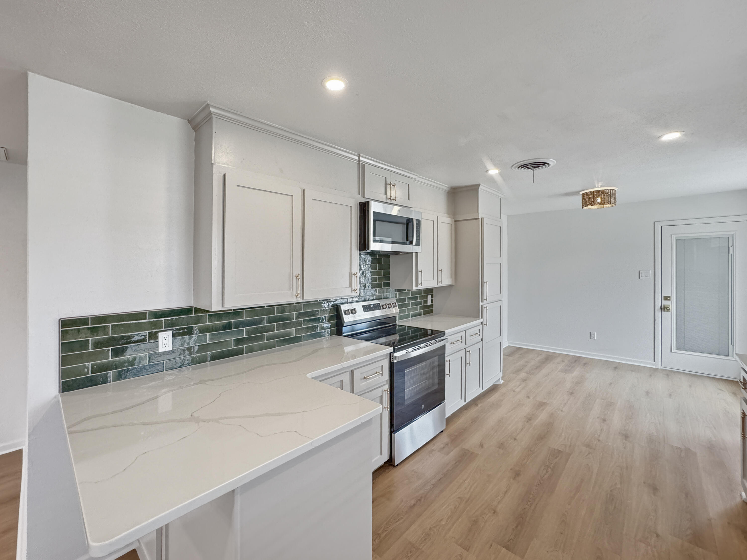 5502 8th Street Lubbock, TX 79416 - Photo 18 of 41 a kitchen with granite countertop a sink and steel appliances