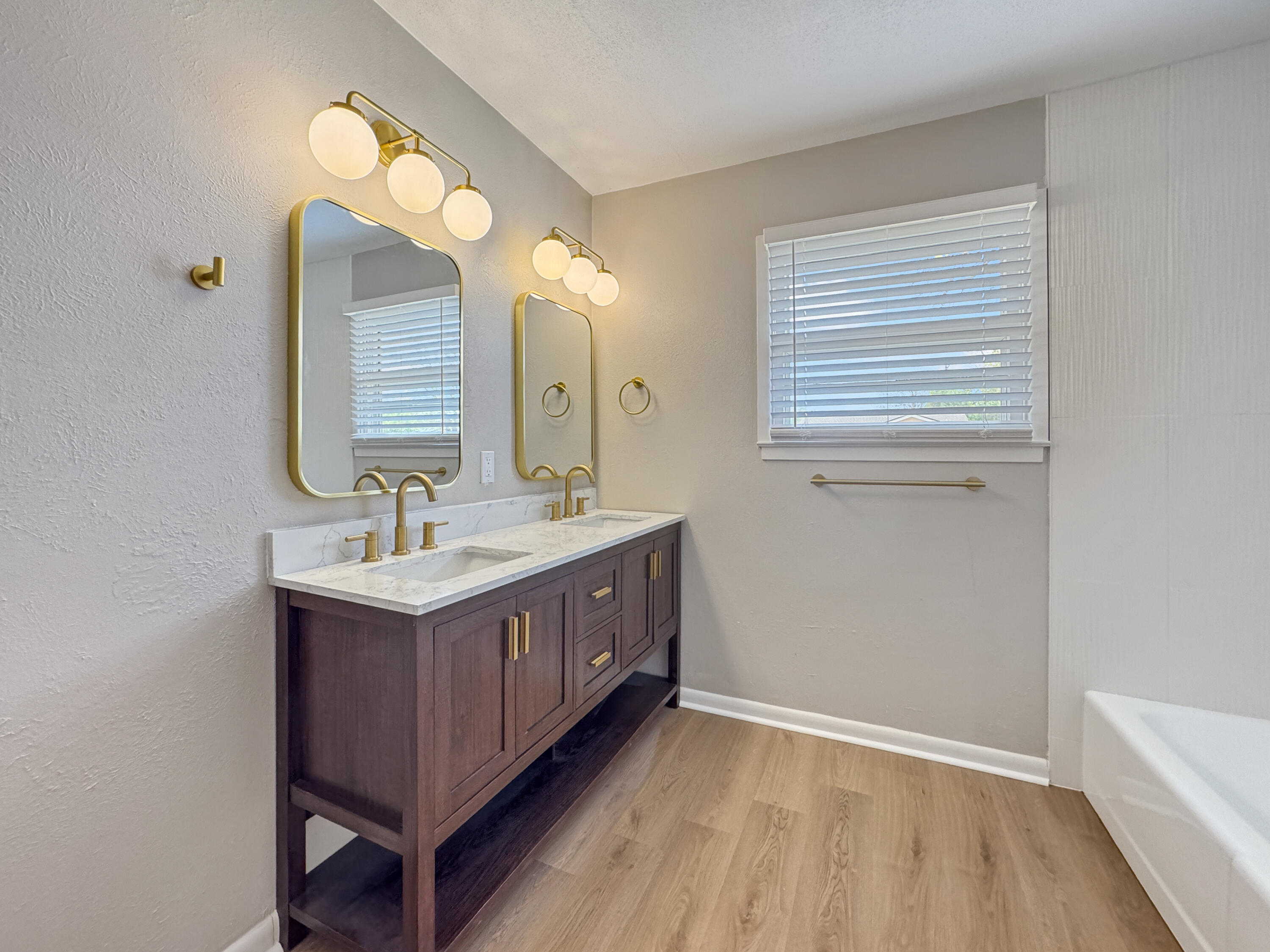 5502 8th Street Lubbock, TX 79416 - Photo 28 of 41 a bathroom with a double vanity sink and a mirror