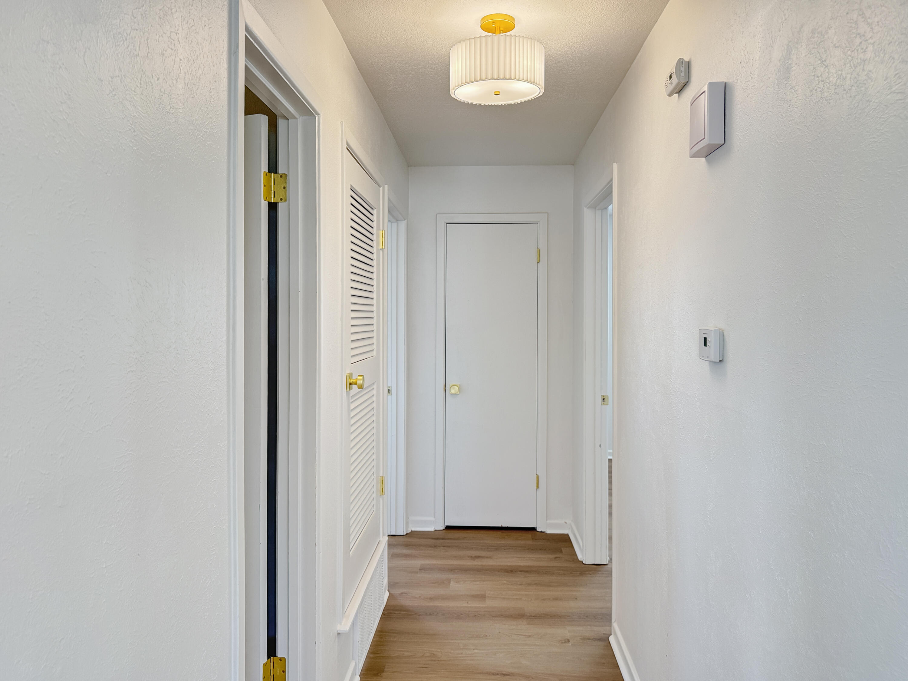 5502 8th Street Lubbock, TX 79416 - Photo 31 of 41 a view of a hallway with wooden floor and closet
