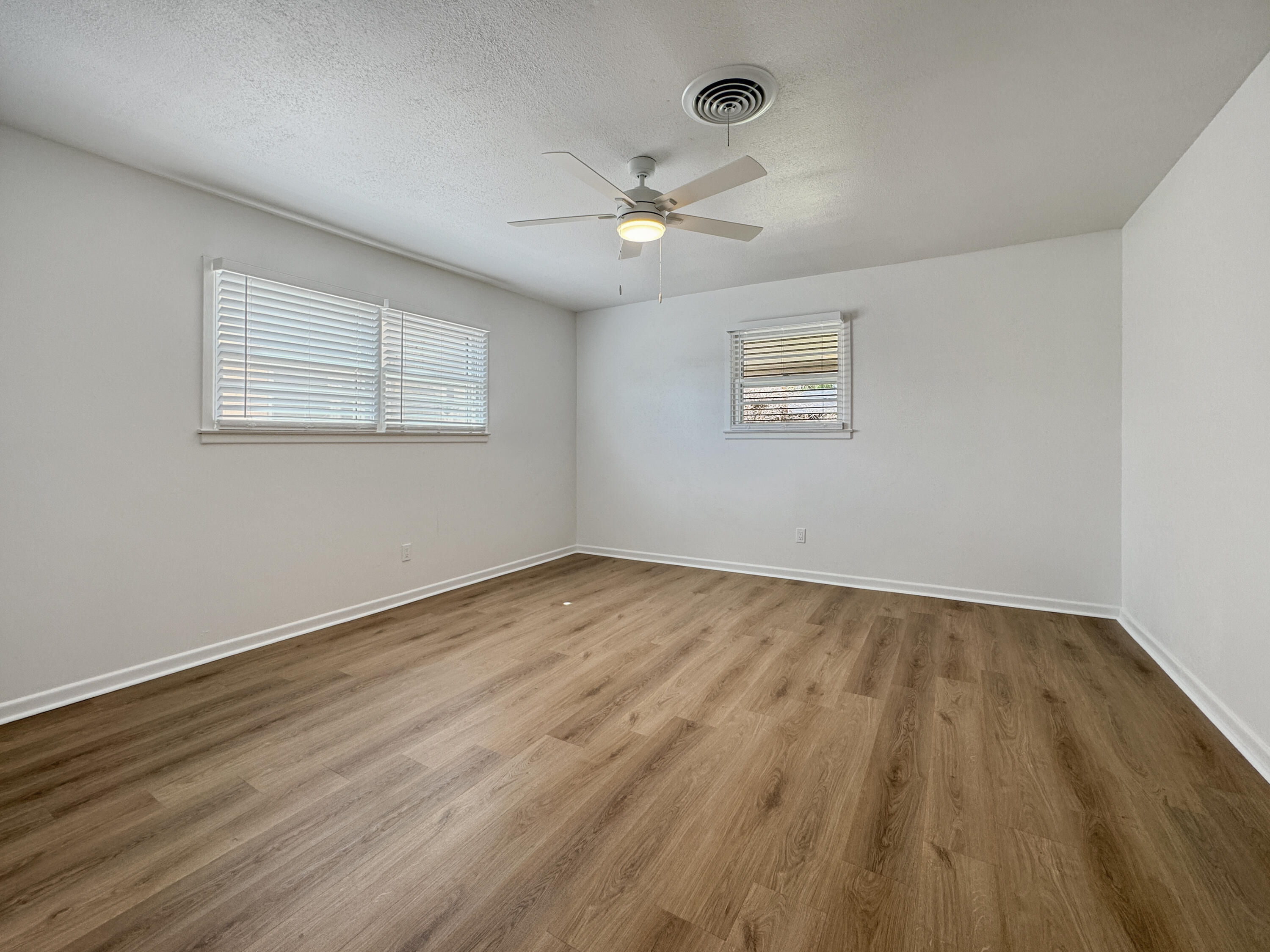 5502 8th Street Lubbock, TX 79416 - Photo 32 of 41 wooden floor in an empty room with a window