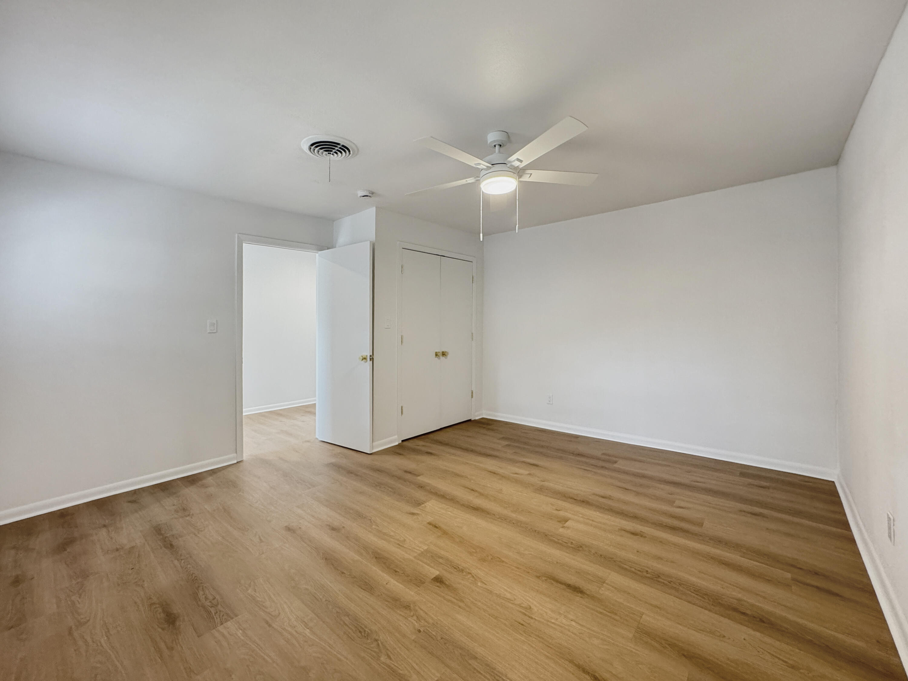 5502 8th Street Lubbock, TX 79416 - Photo 33 of 41 an empty room with wooden floor and fan
