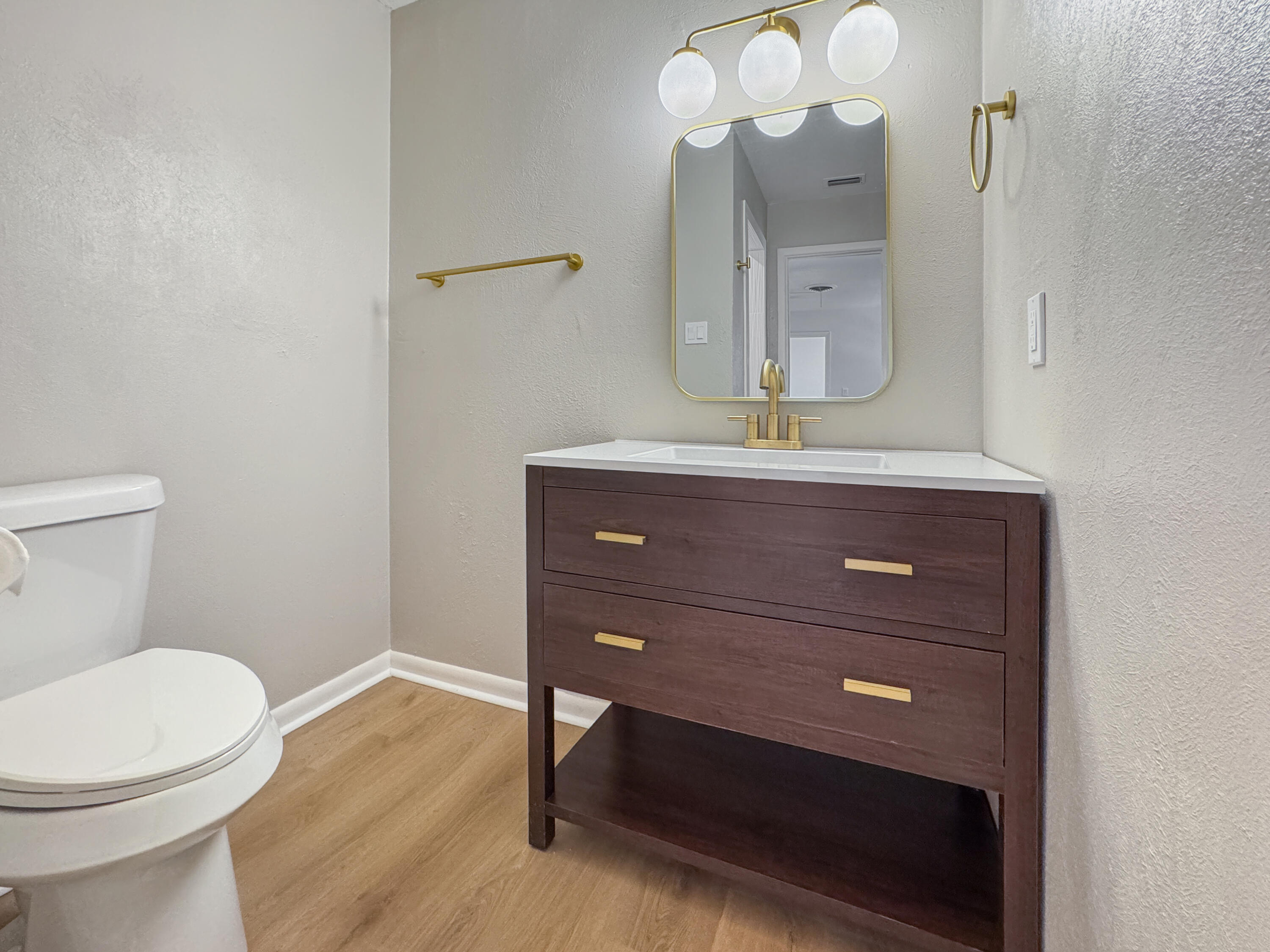 5502 8th Street Lubbock, TX 79416 - Photo 35 of 41 a bathroom with a toilet a sink and mirror