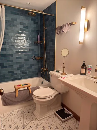 a bathroom with a sink toilet and shower