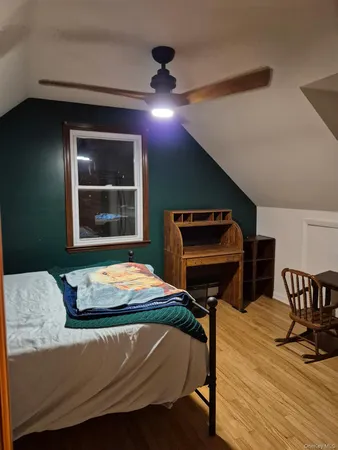 a bedroom with furniture and a window