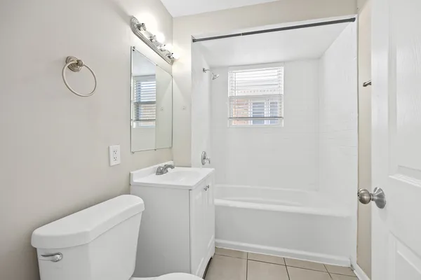 a bathroom with a shower a toilet and a sink