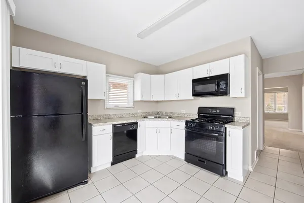 a kitchen with a refrigerator stove and microwave