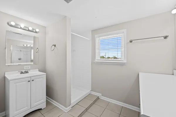 a bathroom with a sink mirror and vanity