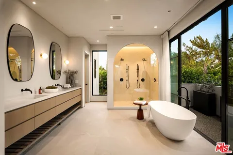 a large bathroom with a double vanity sink and a mirror