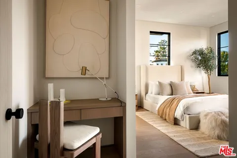 a bed room with a bed and a chair