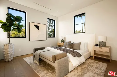 a bedroom with a bed and a potted plant