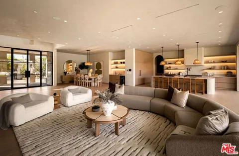 a living room with furniture kitchen and a table