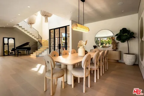 a dining room with furniture a chandelier and window