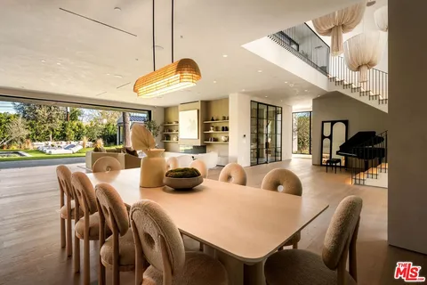 a view of a dining room with furniture wooden floor and chandelier
