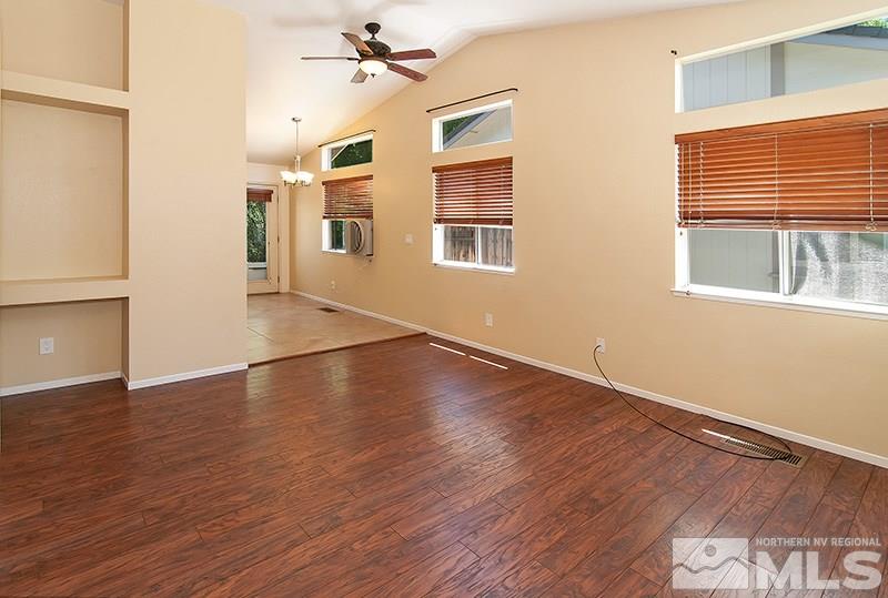 7716 Pickering Circle Reno, NV 89511 - Photo 5 of 15 a view of a livingroom with wooden floor and a ceiling fan