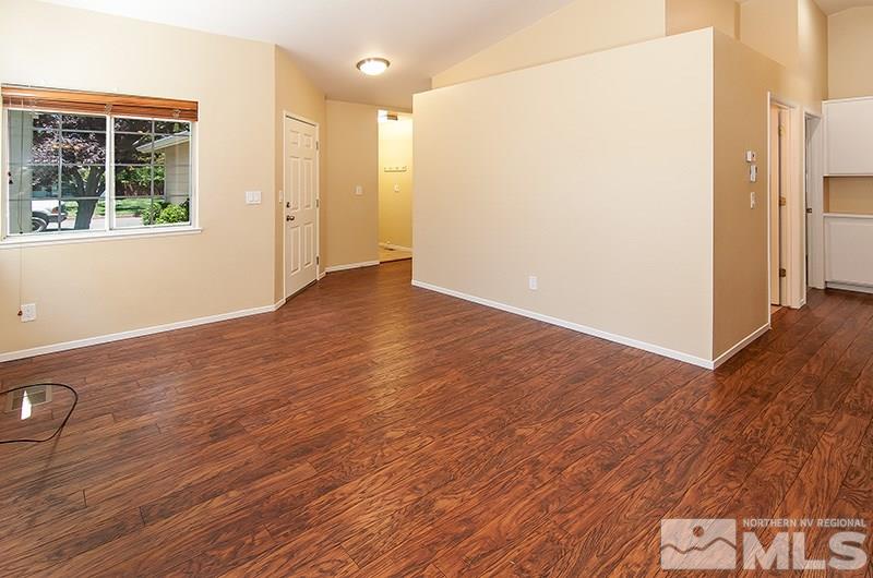7716 Pickering Circle Reno, NV 89511 - Photo 6 of 15 an empty room with wooden floor and windows