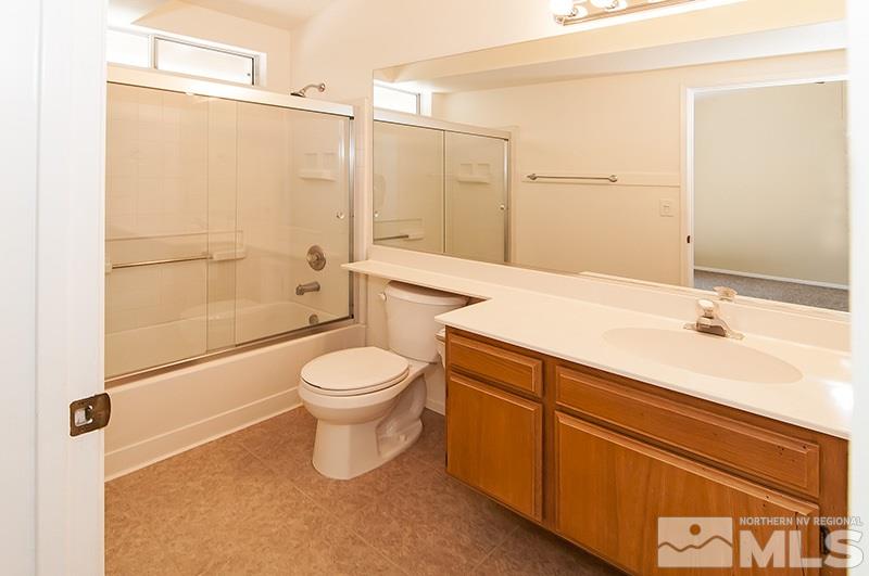 7716 Pickering Circle Reno, NV 89511 - Photo 9 of 15 a bathroom with a toilet a sink and shower