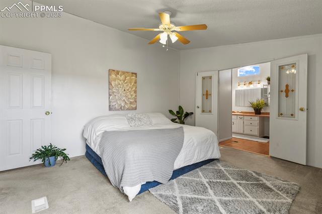 17315 Hopper Road Peyton, CO 80831 - Photo 9 of 20 Primary Bedroom with double doors to primary bath