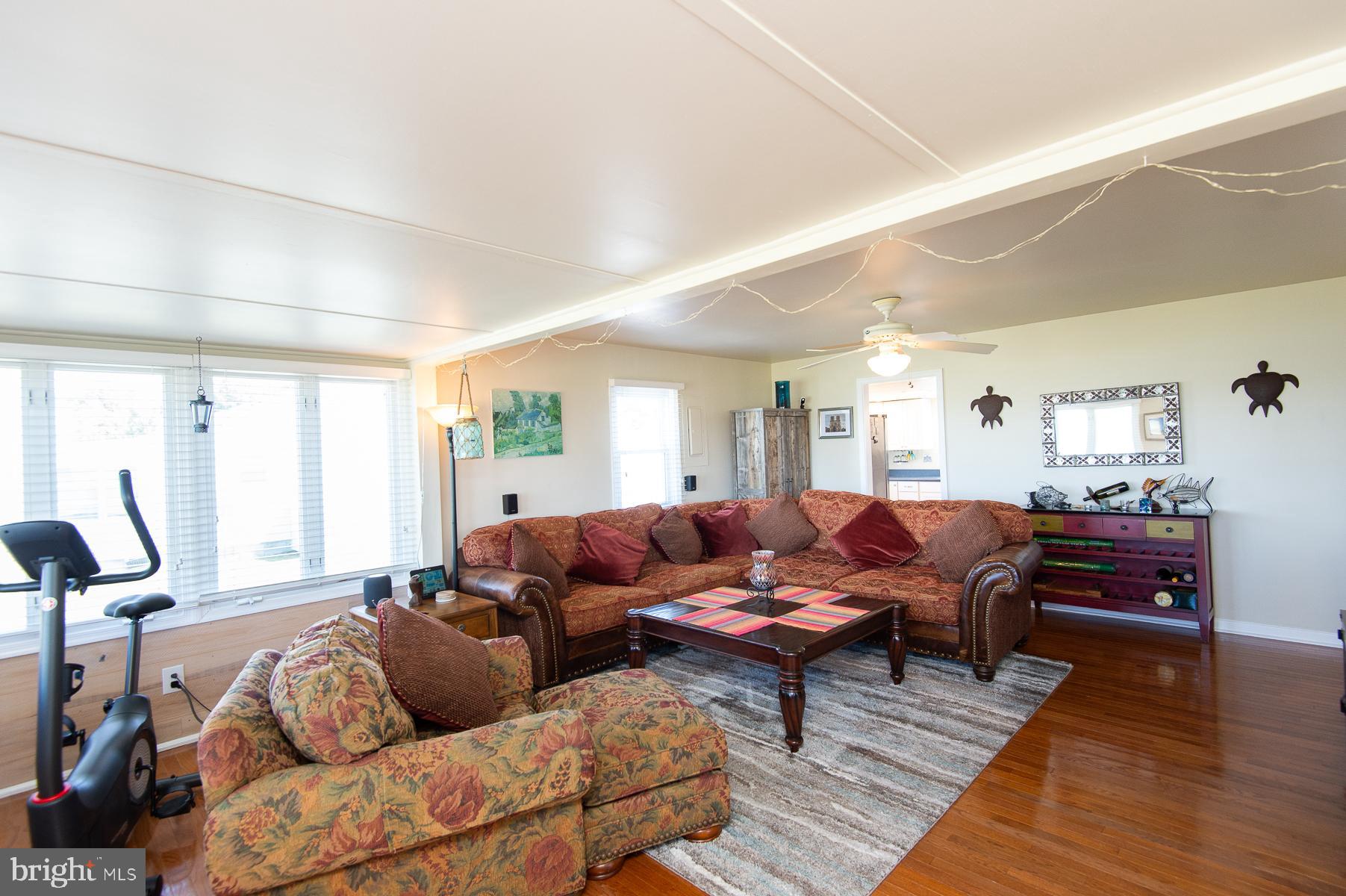 5558 Bowen Road Cambridge, MD 21613 - Photo 9 of 33 a living room with furniture and wooden floor