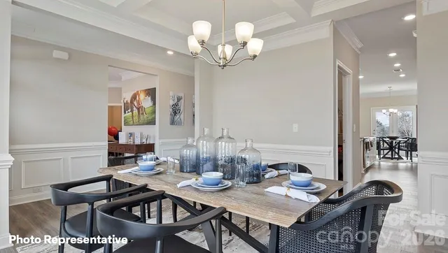 a view of a dining room with furniture and chandelier