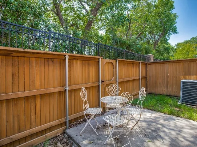 a backyard of a house with table and chairs