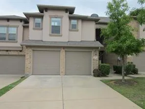 a front view of a house with garage