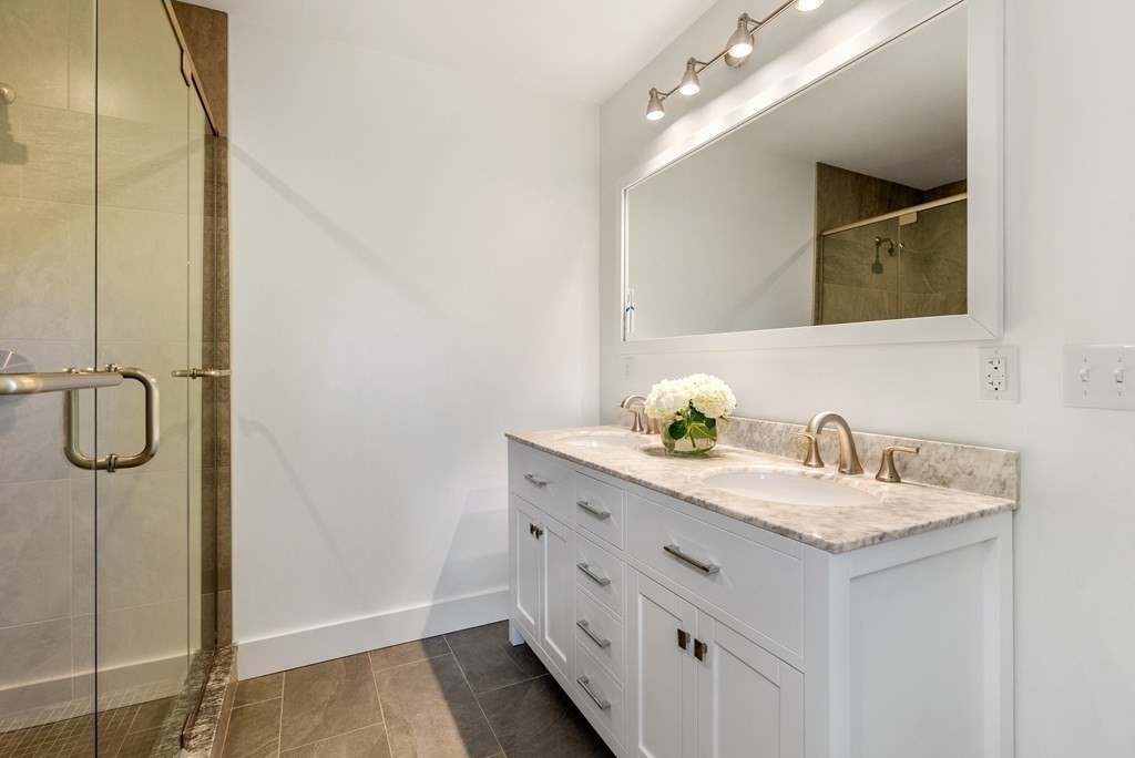 338 South Great Road Lincoln, MA 01773 - Photo 16 of 29 a bathroom with a granite countertop sink and a mirror