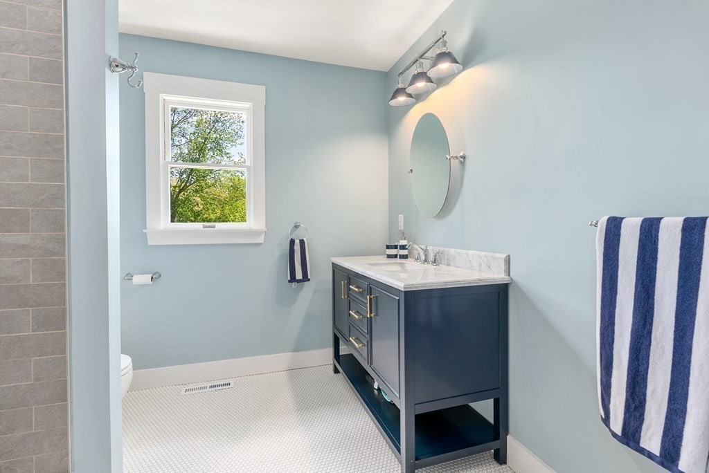 338 South Great Road Lincoln, MA 01773 - Photo 19 of 29 a bathroom with a double vanity sink and mirror