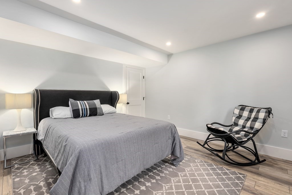 338 South Great Road Lincoln, MA 01773 - Photo 23 of 29 a bedroom with a bed a chair and next to a window