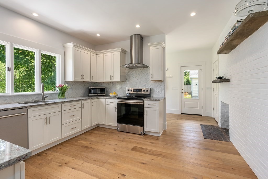 338 South Great Road Lincoln, MA 01773 - Photo 7 of 29 a kitchen with granite countertop white cabinets and appliances