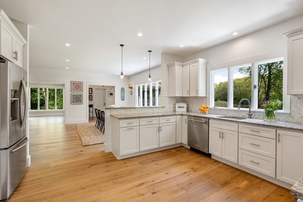 338 South Great Road Lincoln, MA 01773 - Photo 8 of 29 a kitchen with stainless steel appliances granite countertop a stove and a wooden floors