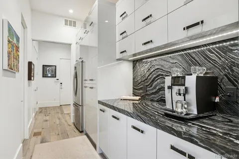 a kitchen with stainless steel appliances kitchen island granite countertop a refrigerator and a stove