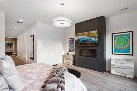 a bedroom with furniture and a flat screen tv