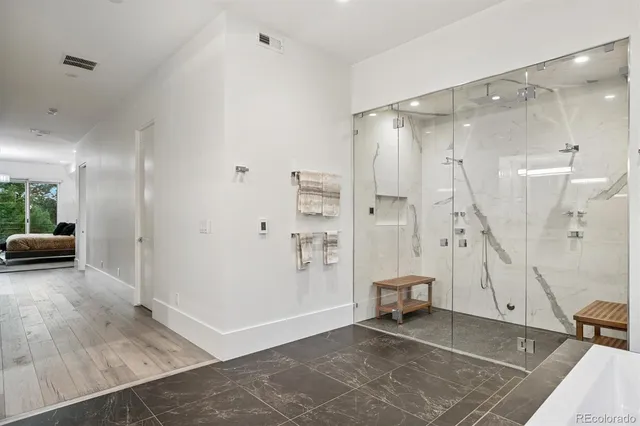 a view of an empty room and a bathroom