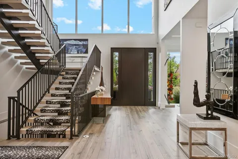 a view of a hallway with wooden floor and entryway