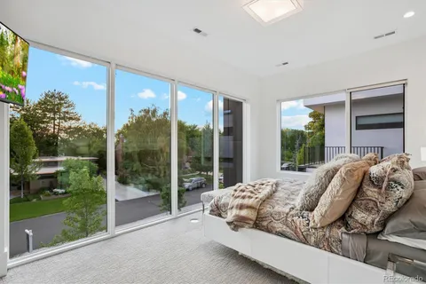 a bed sitting in a bedroom next to a window