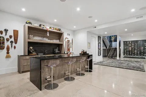 a kitchen with stainless steel appliances kitchen island granite countertop a stove and a sink