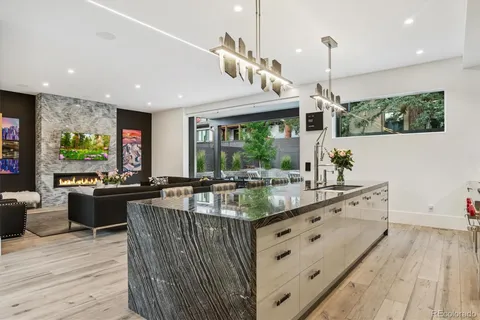 a kitchen with stainless steel appliances granite countertop sink stove and wooden floor