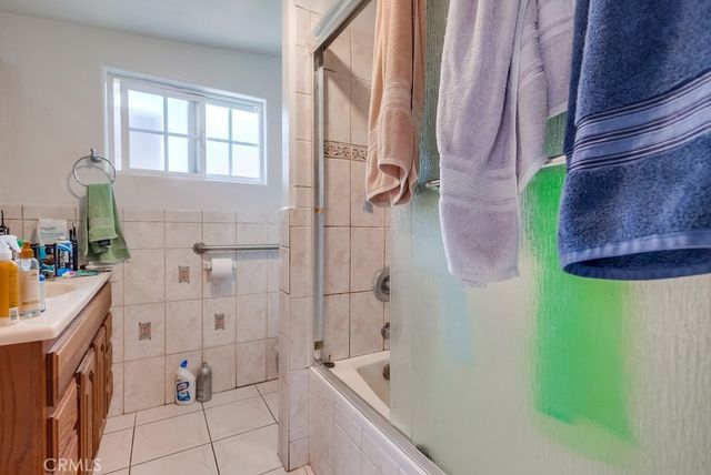 a bathroom with a bathtub sink and mirror