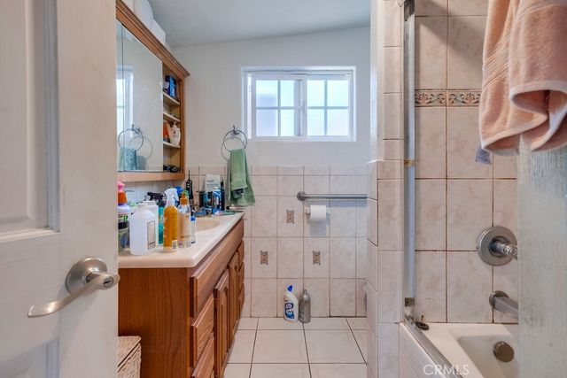 hallway with view of bathroom and a bathroom
