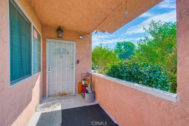 a living room with furniture a flat screen tv and a window