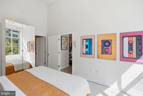 a bedroom with a bed and glass wall