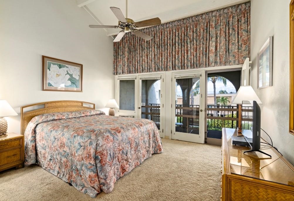2881 South Kihei Road, Unit 100 Kihei, HI 96753 - Photo 11 of 32 a spacious bedroom with a bed and a table in it