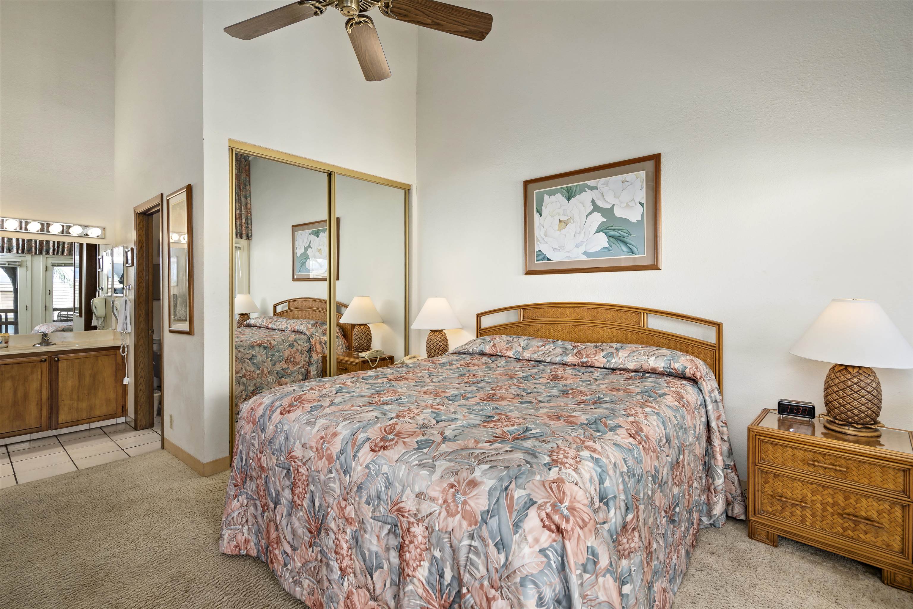 2881 South Kihei Road, Unit 100 Kihei, HI 96753 - Photo 12 of 32 a bedroom with a bed and a view of bathroom