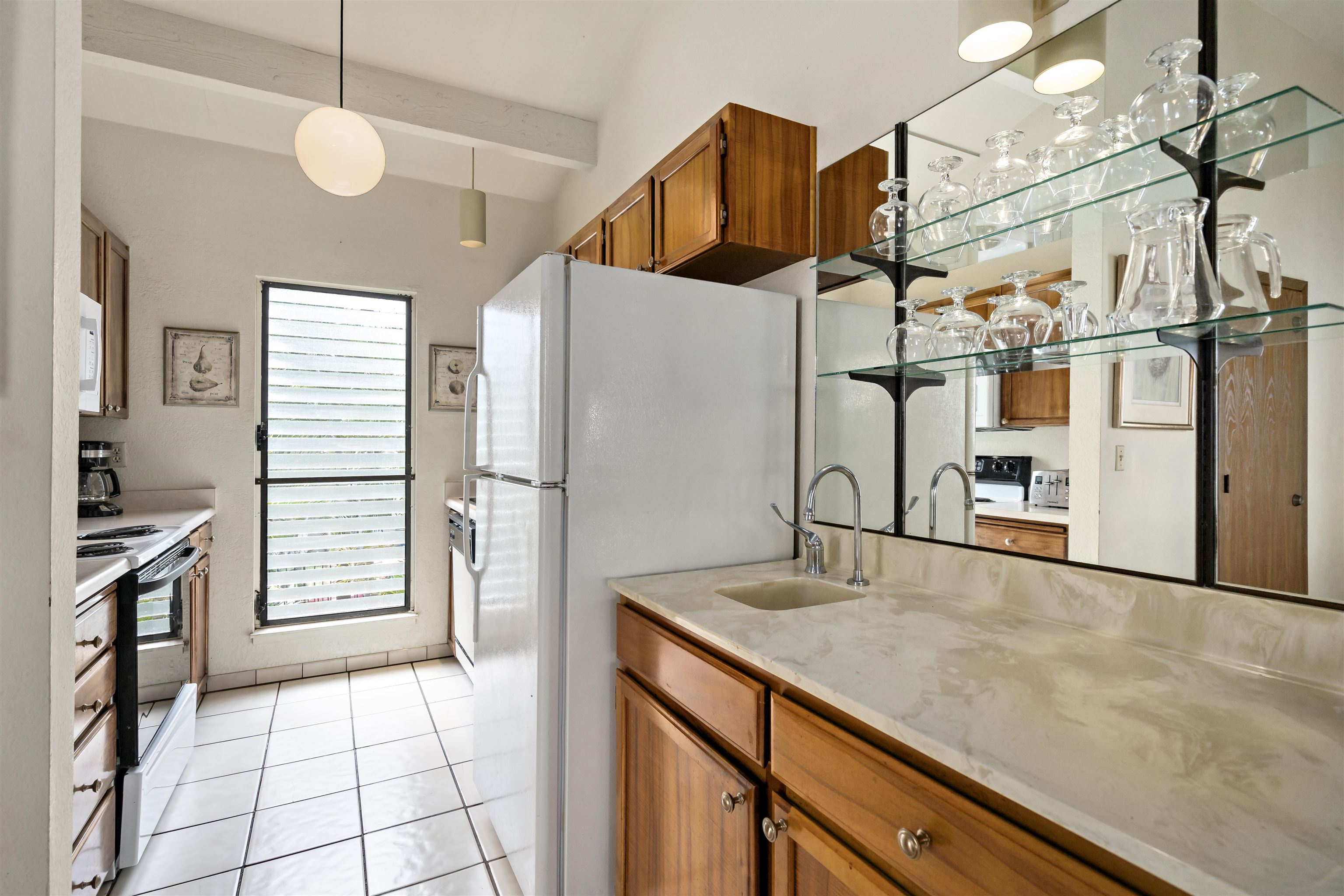 2881 South Kihei Road, Unit 100 Kihei, HI 96753 - Photo 15 of 32 a kitchen with a sink cabinets and appliances