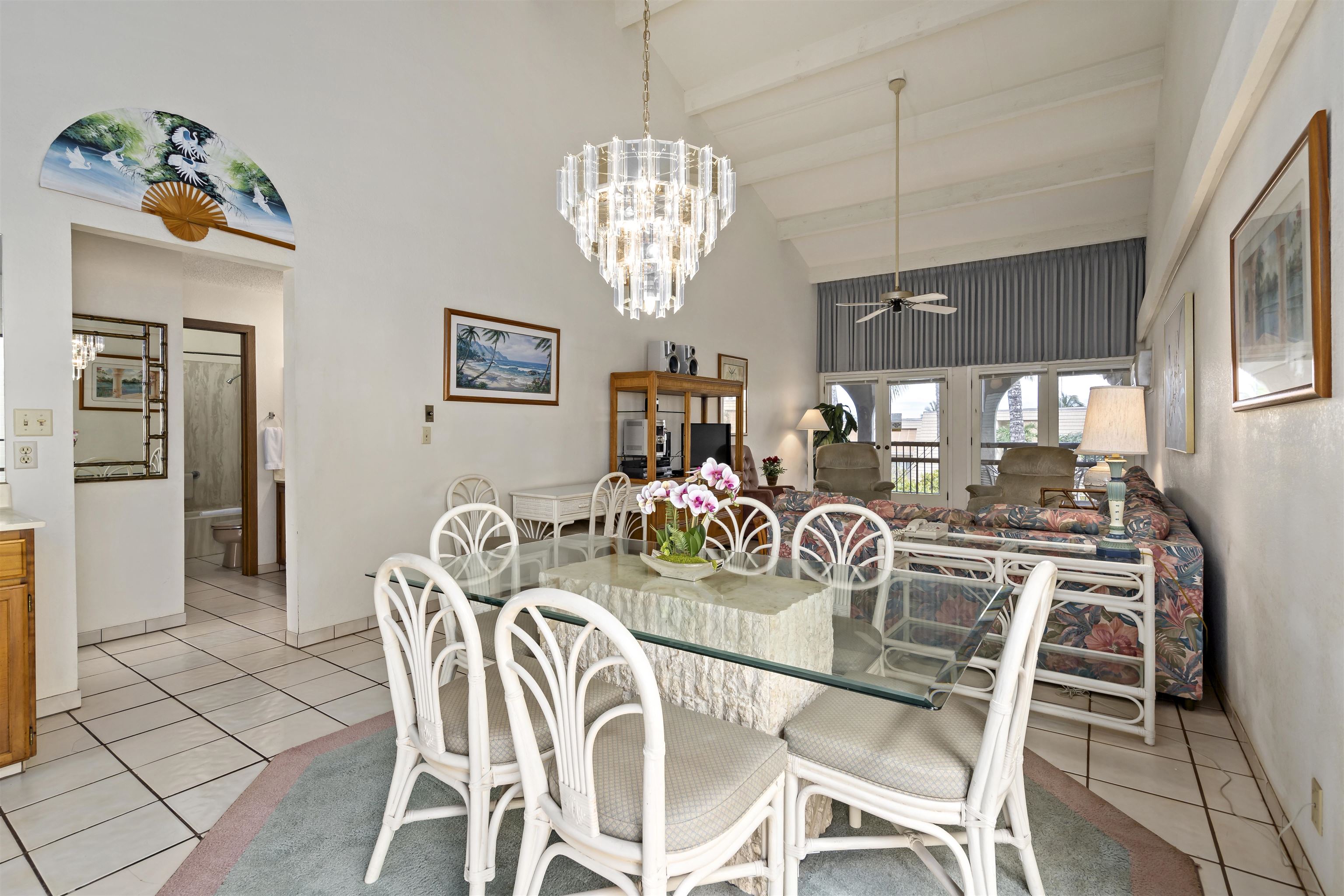 2881 South Kihei Road, Unit 100 Kihei, HI 96753 - Photo 17 of 32 a view of a dining room with furniture a chandelier and wooden floor