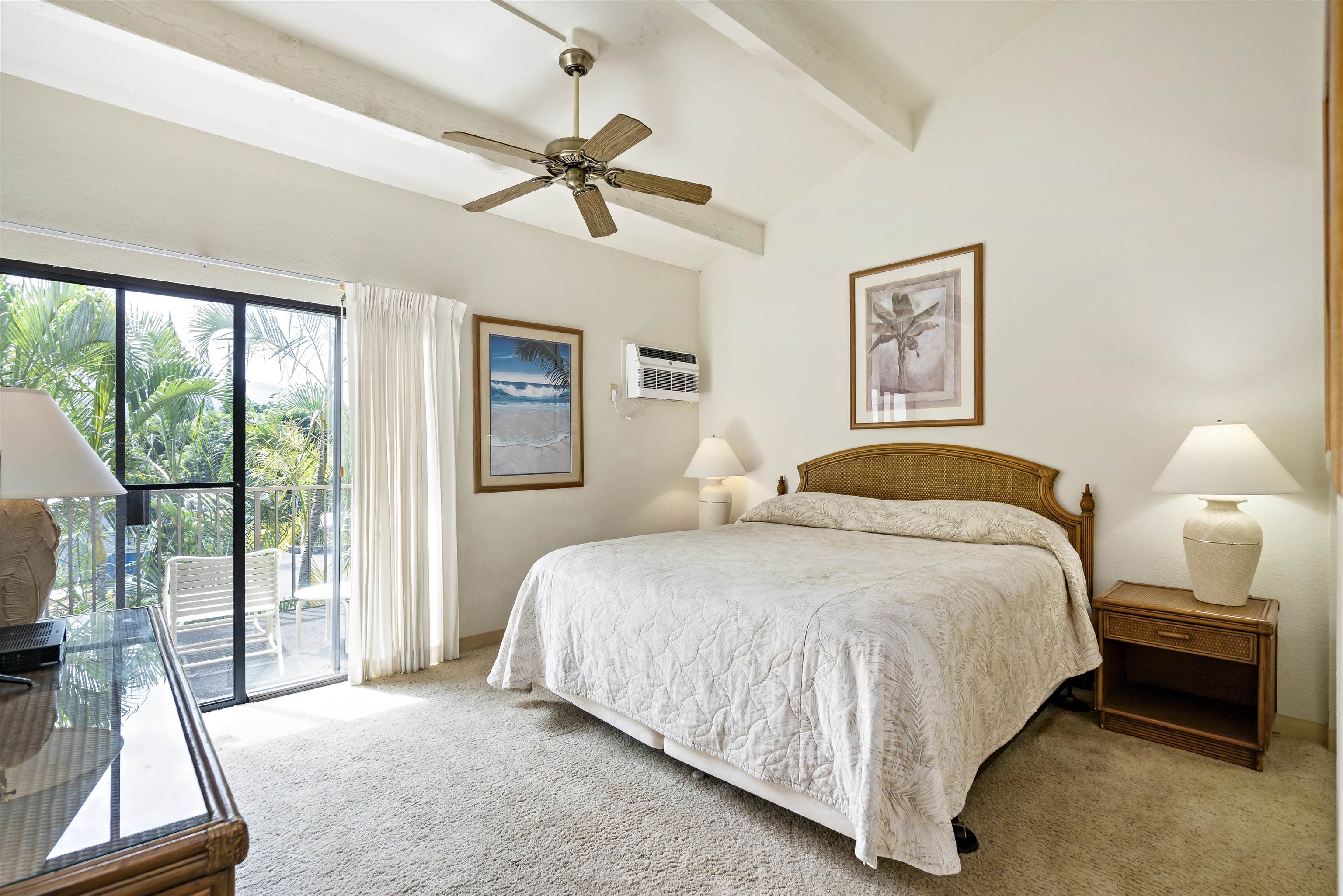 2881 South Kihei Road, Unit 100 Kihei, HI 96753 - Photo 24 of 32 a bedroom with a bed lamp and window