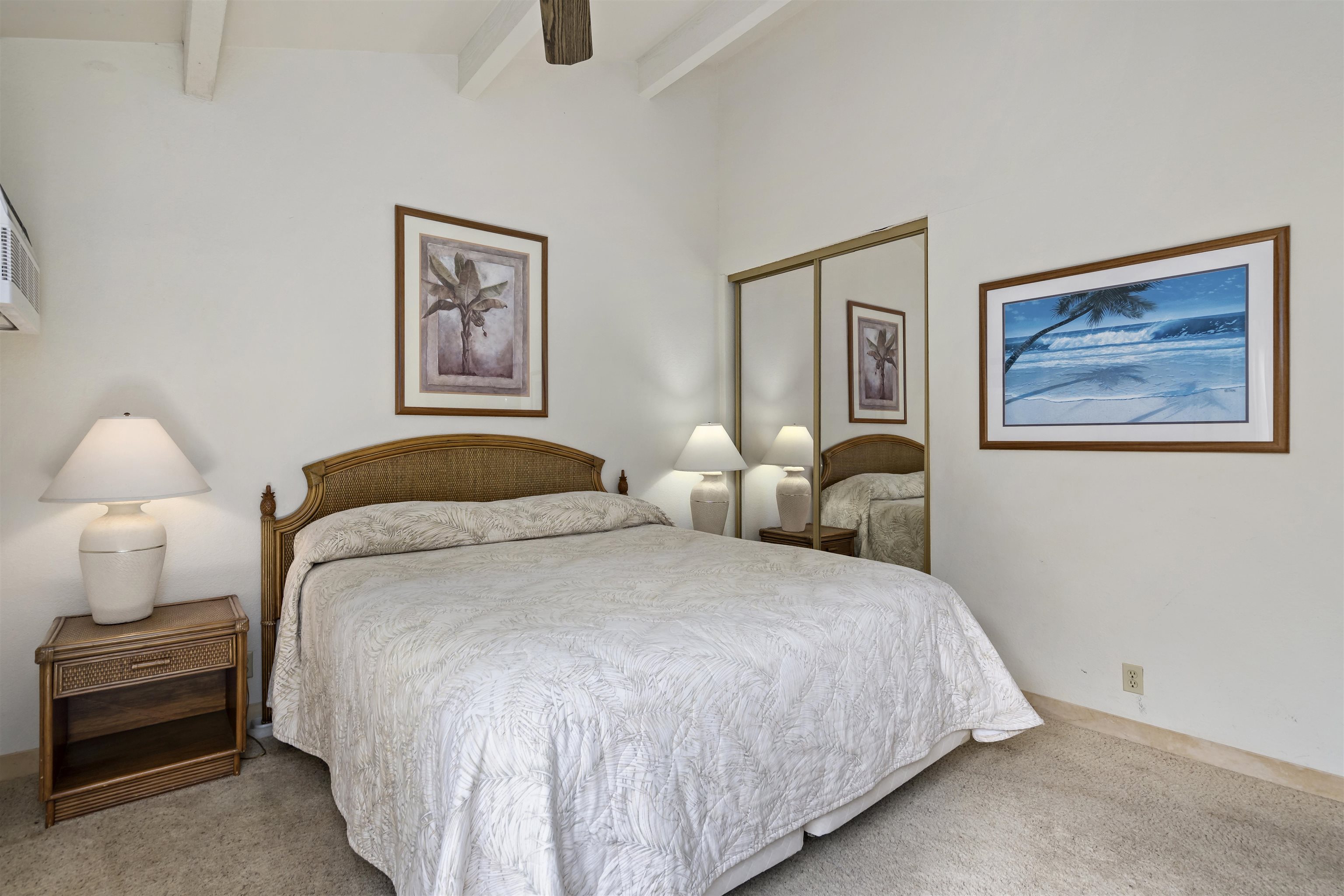 2881 South Kihei Road, Unit 100 Kihei, HI 96753 - Photo 25 of 32 a bedroom with a bed and a painting on the wall