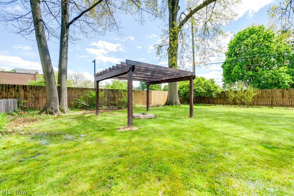 3569 Elm Road Stow, OH 44224 - Photo 16 of 17 Expansive green lawn featuring a wood pergola and a stone fire pit